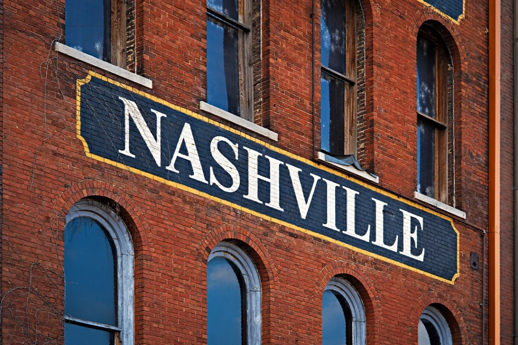 Nashville Sign on the side of a brick wall. 